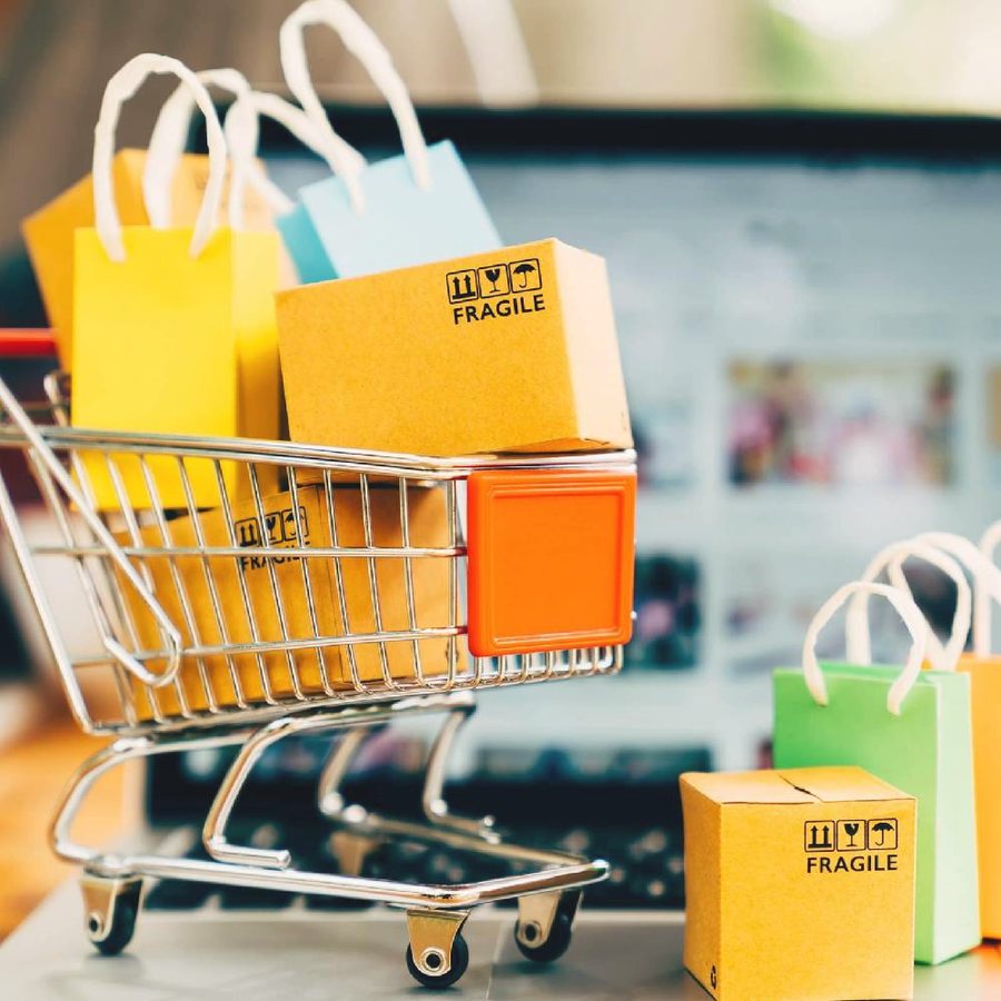 Colorful shopping bags and parcels in a small cart